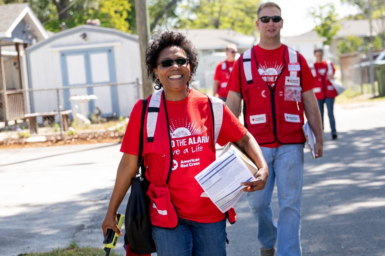 April 28, 2018. Wilmington, North Carolina.Smoke alarm installations at the Sound the Alarm event.Pictured: American Red Cross volunteers Carol Schwarzenbach and Jonathan FehrAmerican Red Cross volunteer Carol Schwarzenbach, Jonathan Fehr and their team go door-to-door in Wilmington, North Carolina during an event called  "Sound the Alarm." Teams of Red Cross volunteers fan out into local neighborhoods across the country, offering to install free smoke alarms in any home that needs them. As part of the installation they also teach families about fire prevention, and help them design escape plans, so they can practice how to get out of the building quickly in the event of a fire.Photo by Adam Jennings for the American Red Cross.