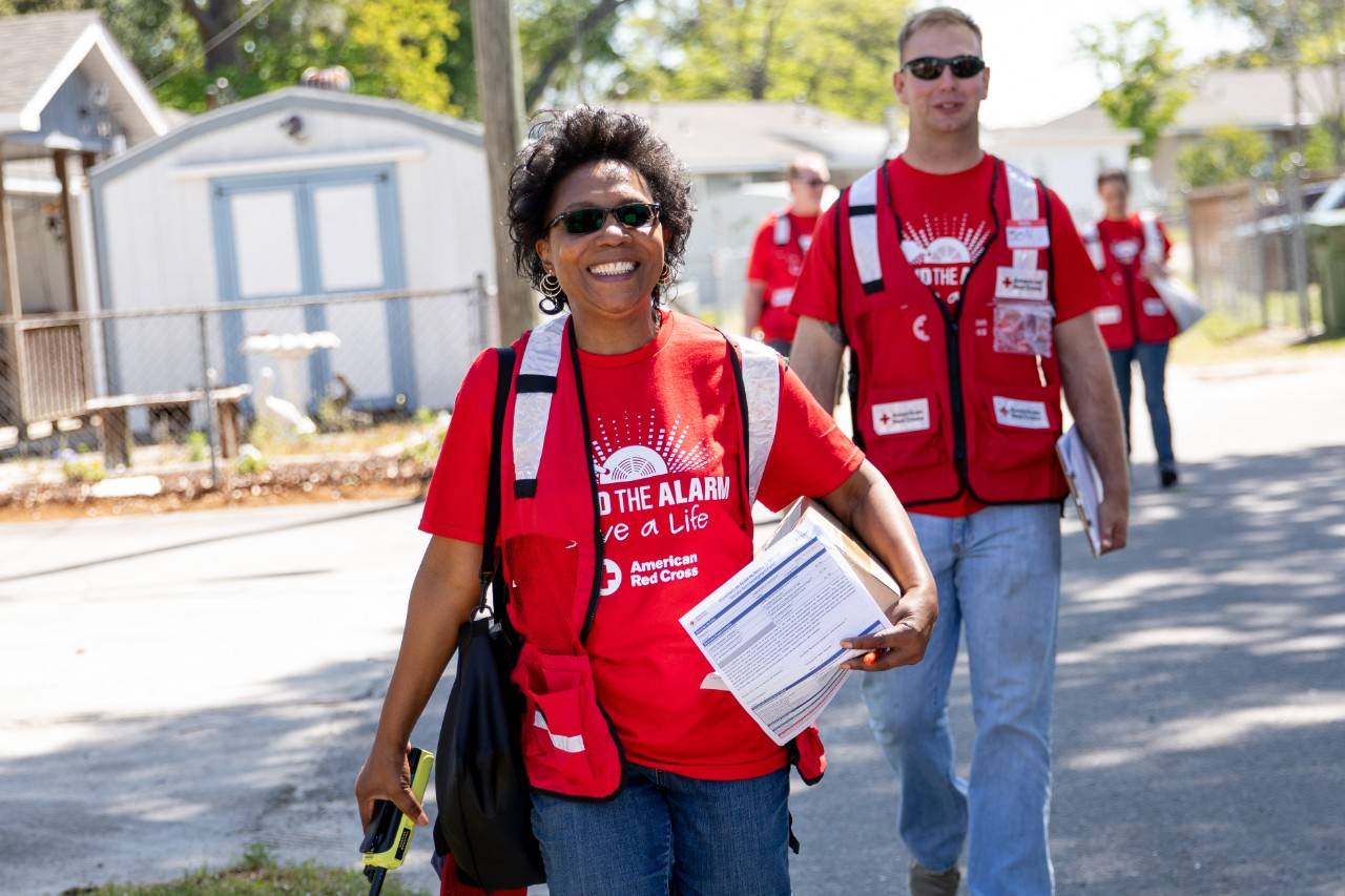 April 28, 2018. 
Wilmington, North Carolina.
Smoke alarm installations at the Sound the Alarm event.
Pictured: American Red Cross volunteers Carol Schwarzenbach and Jonathan Fehr

American Red Cross volunteer Carol Schwarzenbach, Jonathan Fehr and their team go door-to-door in Wilmington, North Carolina during an event called  "Sound the Alarm." Teams of Red Cross volunteers fan out into local neighborhoods across the country, offering to install free smoke alarms in any home that needs them. As part of the installation they also teach families about fire prevention, and help them design escape plans, so they can practice how to get out of the building quickly in the event of a fire.

Photo by Adam Jennings for the American Red Cross.