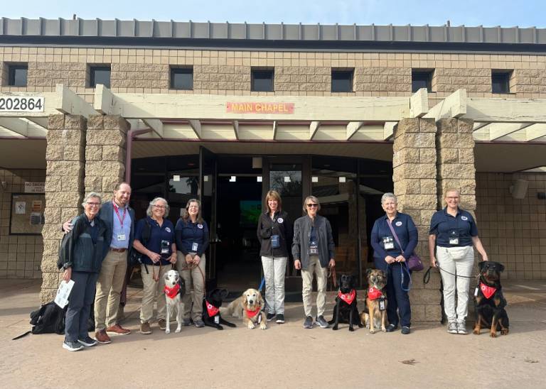 group of K9 teams smiling 