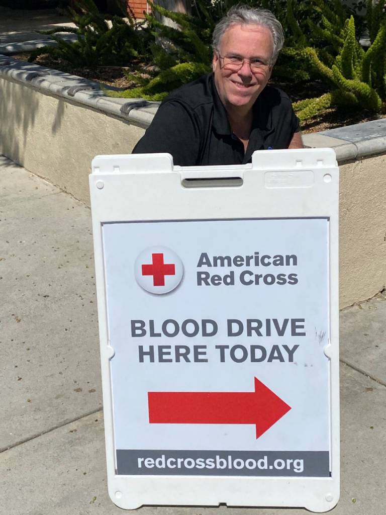 red cross volunteer at blood drive