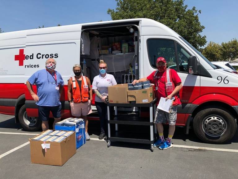 Red Cross volunteers in front of  Red Cross vehicle