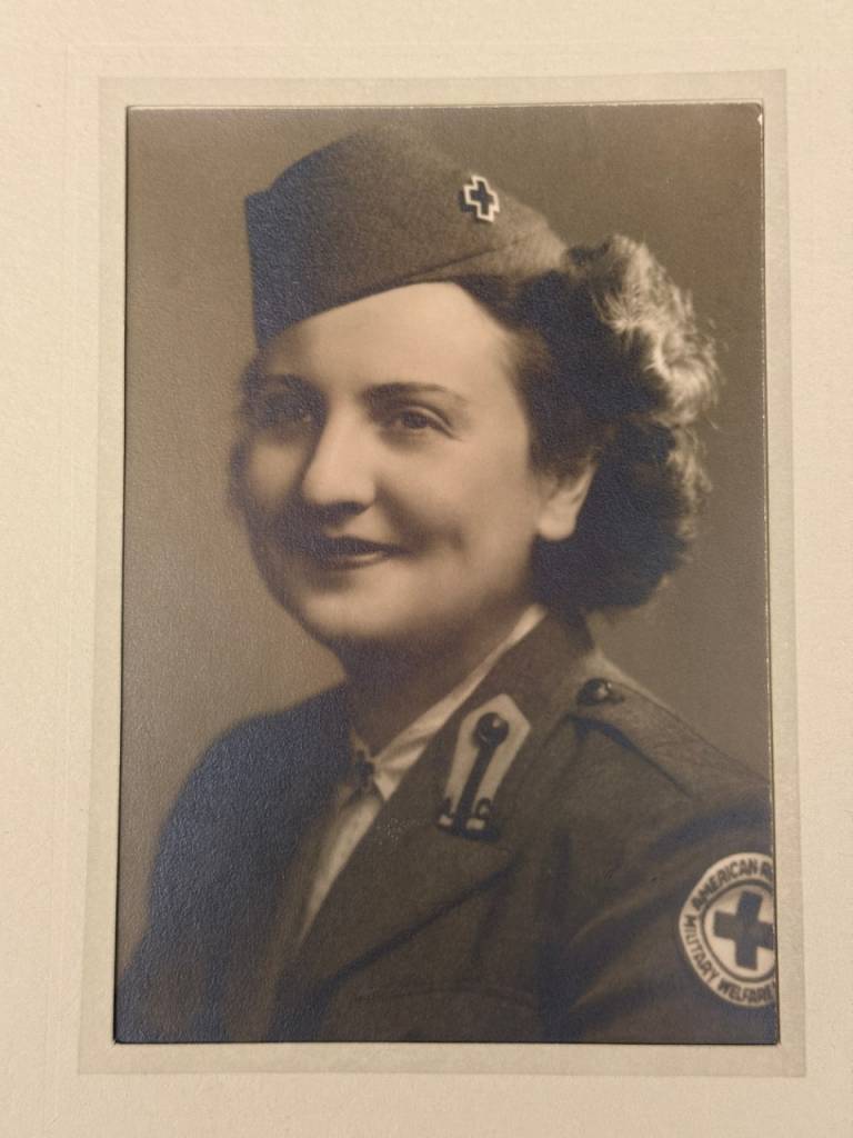 Black and white photo of woman smiling in a Red Cross uniform