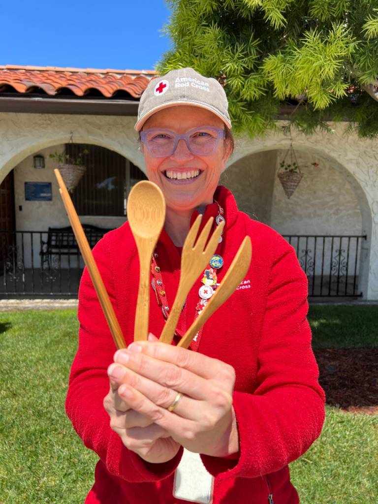 Himne Dress holding up bamboo reusable utensils
