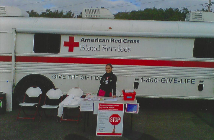 Laura Nguyen in front of an American Red Cross Blood Services vehicle