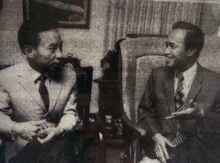 Brothers Mau and Sam Nguyem sit in their living room