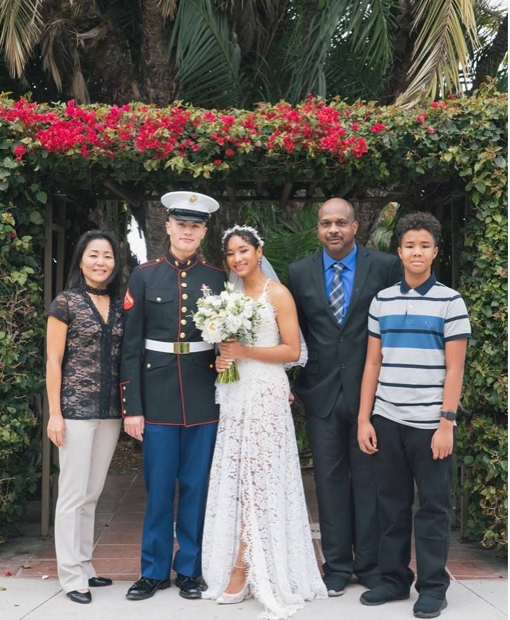 Myka pictured with her husband and family at her wedding.