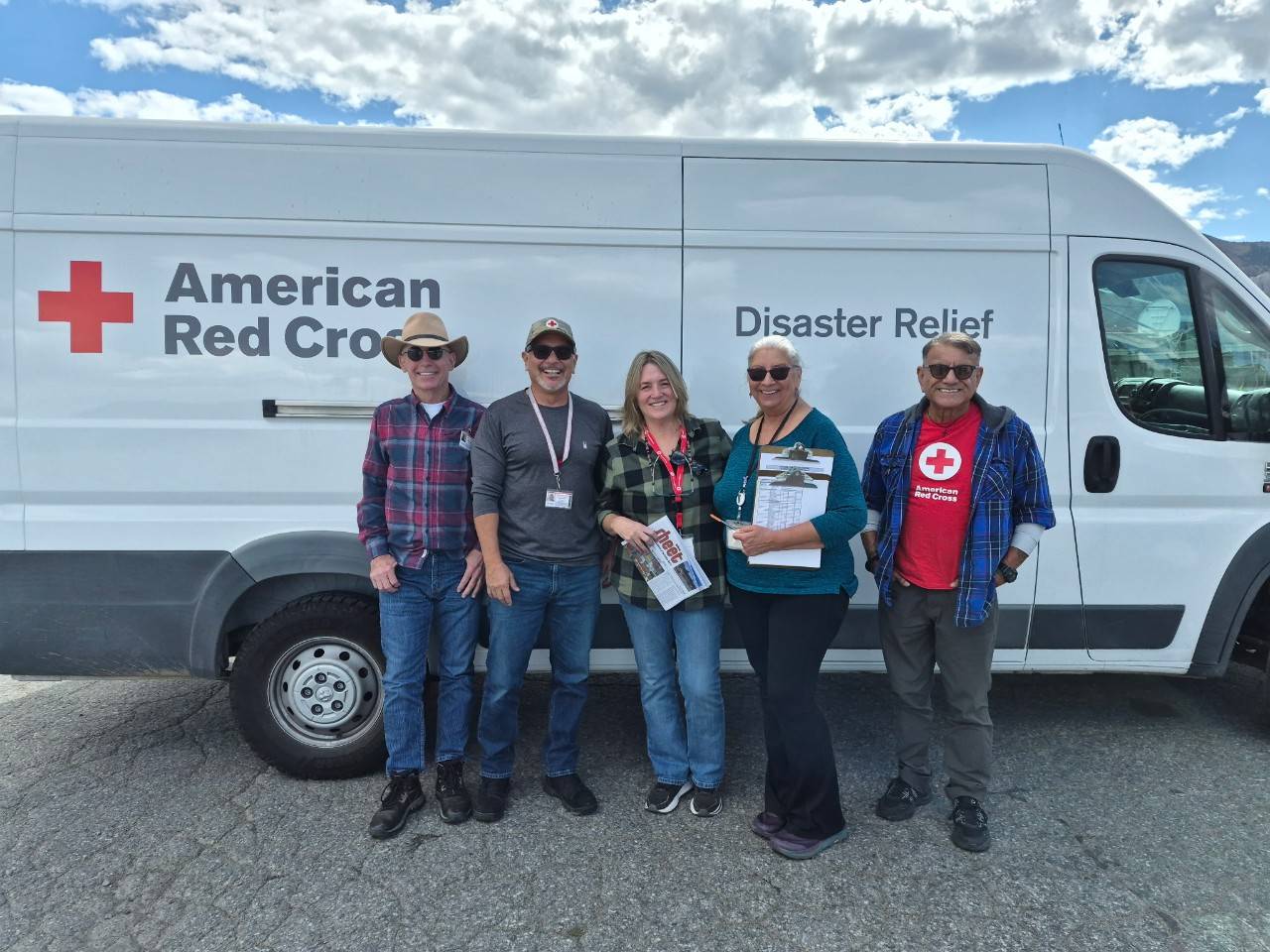 Group of Red Cross volunteers in front of disaster vehicle
