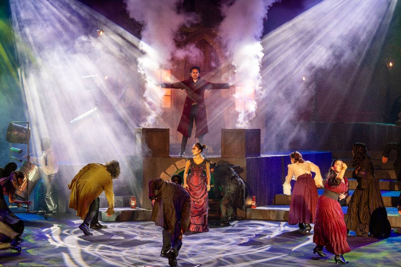 Theatrical performance image with several performers.