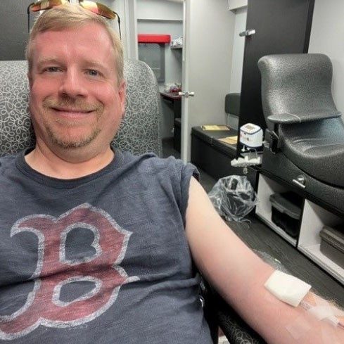 Andrew Holladay laying in cot donating blood