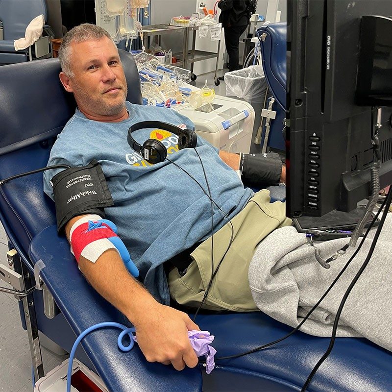 James Braun laying in cot donating blood.