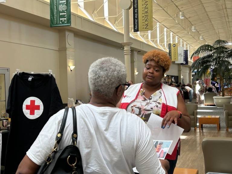 Aja Johnson speaking with resident about Red Cross services