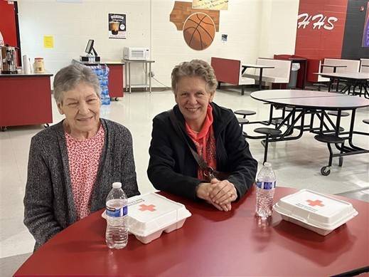 Paula Williams and her daughter, Darlene Newsome, eating a warm meal at the Hillcrest High shelter in Greenville Co., SC.