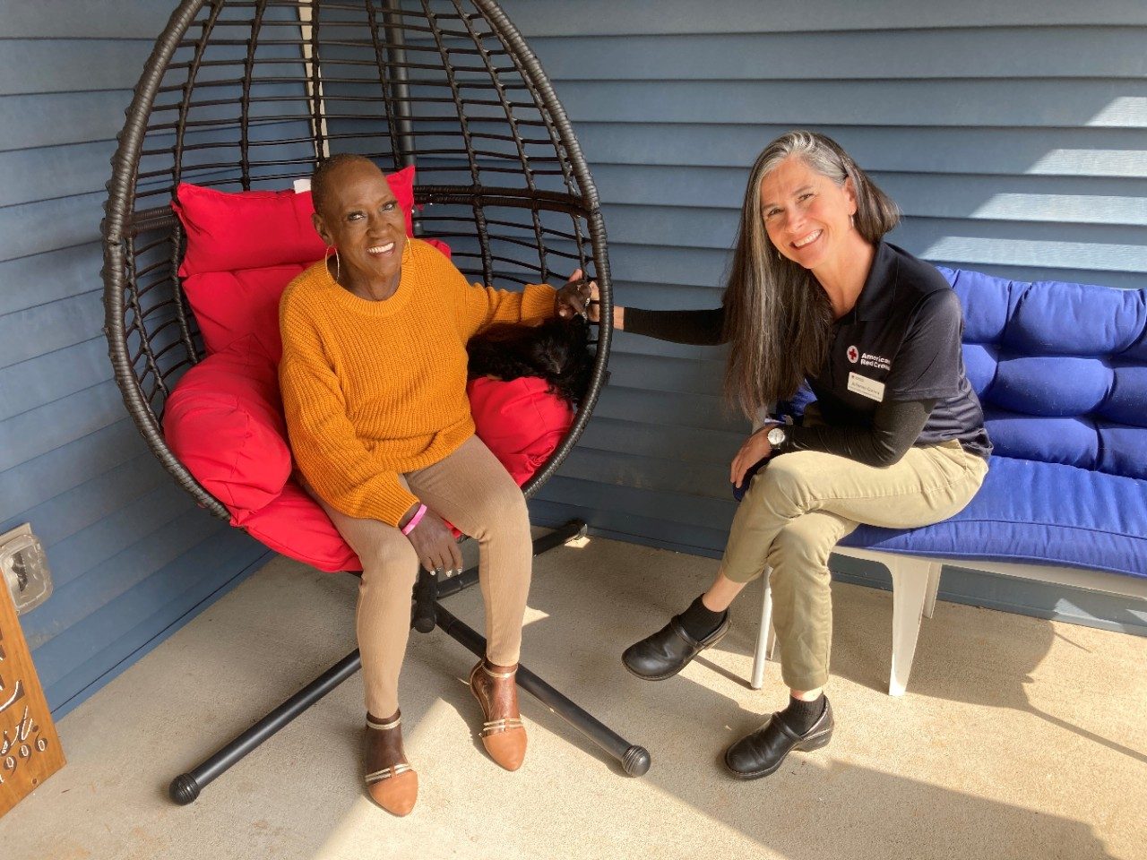 red cross volunteer and client sitting and talking