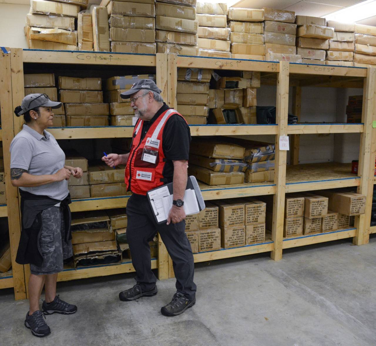Myrtle Beach, South Carolina, September 6, 2019. American Red Cross volunteer Maria Millan explains to Red Cross volunteer Bob Wallace the warehouse operation and distribution of disaster supplies to people who have been affected by Hurricane Dorian. Maria is a Logistics Generalist Manager for the South Carolina disaster response. Over the past 5 years, she has been a volunteer responder to approximately 44 disaster response operations. When not responding to disasters, Maria serves as the Red Cross Logistics Regional Lead volunteer for the state of New York.Photo Credit: Daniel Cima/American Red Cross