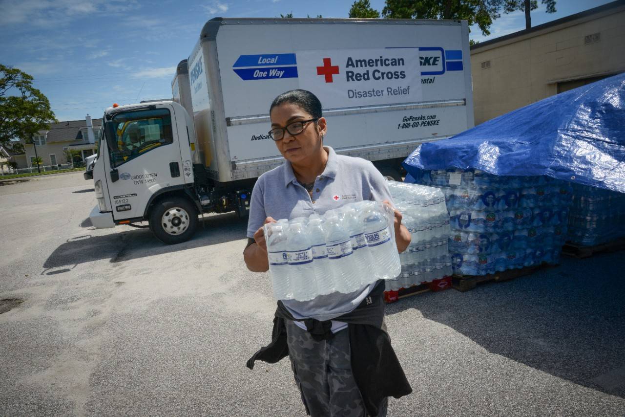 Myrtle Beach, South Carolina, September 6, 2019. American Red Cross volunteer Maria Millan, a Logistics Generalist Manager, loads a case of water at a Red Cross disaster supply warehouse. 
Photo Credit: Daniel Cima/American Red Cross
