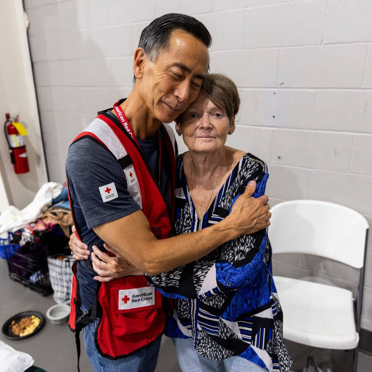 September 1, 2023. Valdosta, Georgia.
Red Cross disaster responder, Ming Yao, comforts Barbara R. Curl, who sought refuge from Hurricane Idalia at a Red Cross shelter in Valdosta, Georgia. Barbara, whose home was left unlivable by Idalia’s strong winds and devastating storm surge, is appreciative of the support she’s received from the Red Cross, especially Ming. “He has been so loving, everyone has been so kind, and I am so pleased with the staff, I promise,” said Barbara. Due to the climate crisis, hurricanes are becoming more intense and destructive with higher rainfall and storm surges.
Photo by Scott Dalton/American Red Cross