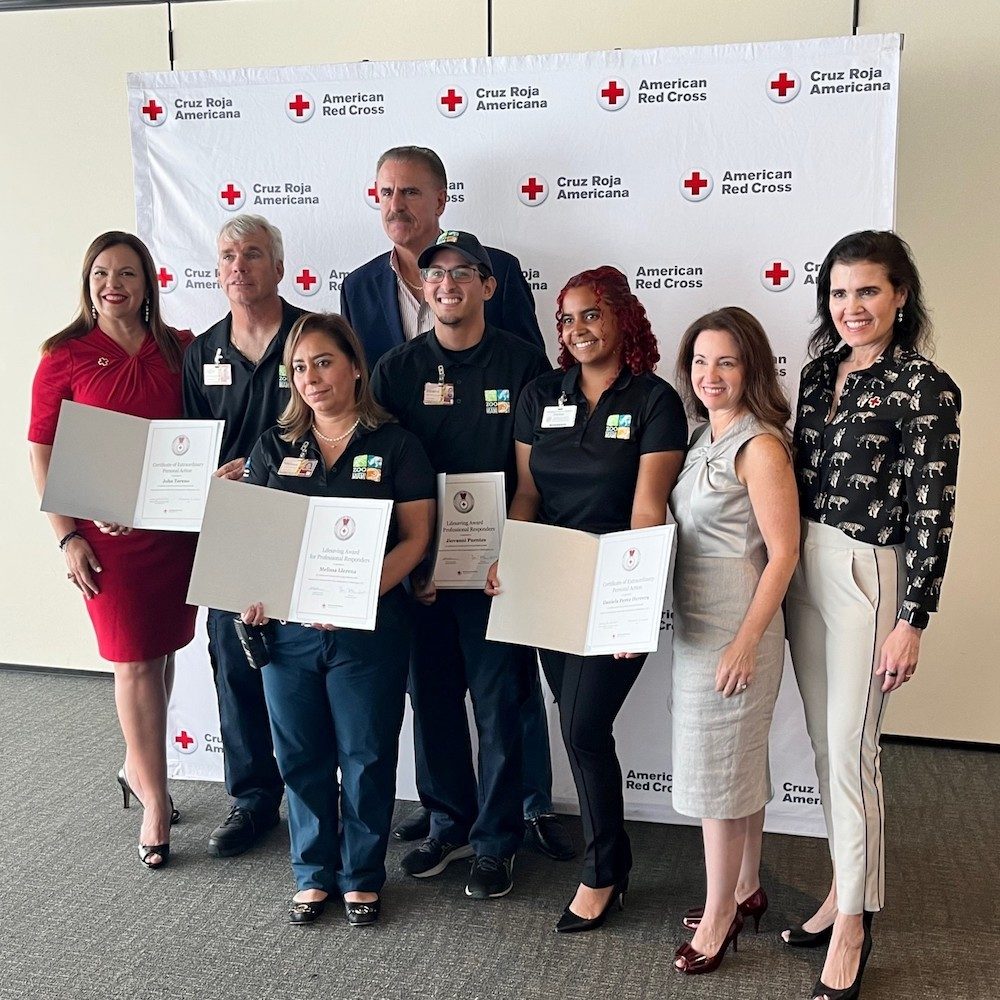 Group of individuals holding award certificates