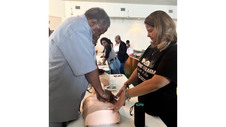 An individual performing CPR on a mannequin