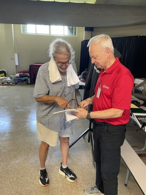 Gary Weinstein helping a person at a shelter.