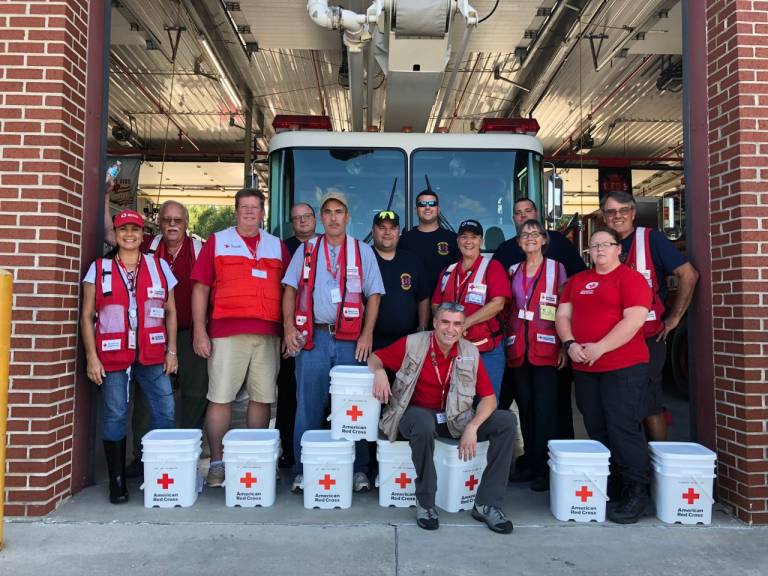 Clara and Red Cross volunteers with firemen in Louisiana.
