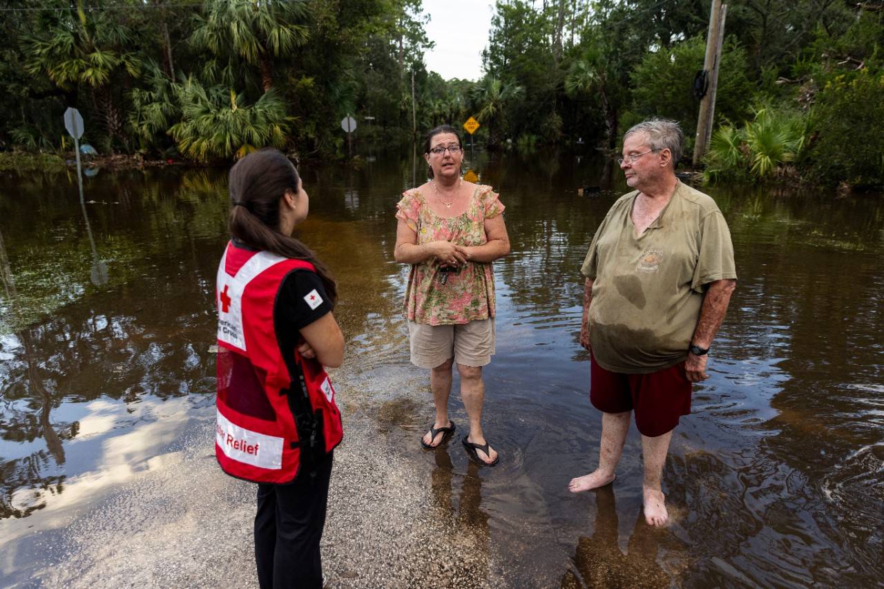 August 30, 2023. Steinhatchee, Florida.
Red Cross disaster responder, Dariana Molina, speaks with Lynn and Shane Padgett of Steinhatchee, Florida. The Padgett s home was severely flooded by the storm surge caused by Hurricane Idalia. Idalia was the fifth major hurricane they ve lived through, but this is the most damage they ve experienced. Despite the devastation, Lynn tries to keep a hopeful spirit, saying  what else can you do besides keep going?  As a result of the climate crisis, hurricanes are becoming more intense and more destructive with increased rainfall and higher storm surges.
Photo by Scott Dalton/American Red Cross