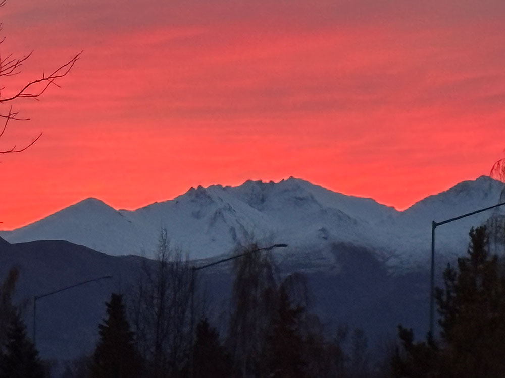 Snow covered mountains and a dusk sky in Alaska.