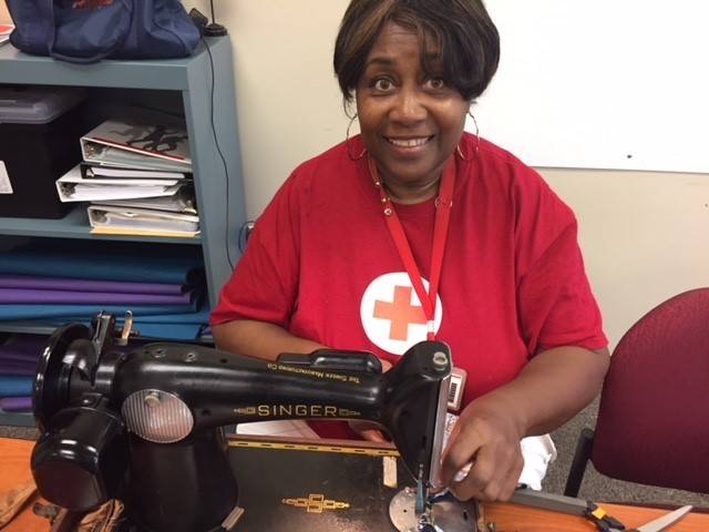 DJ Johnson-Hubbard sews a stocking