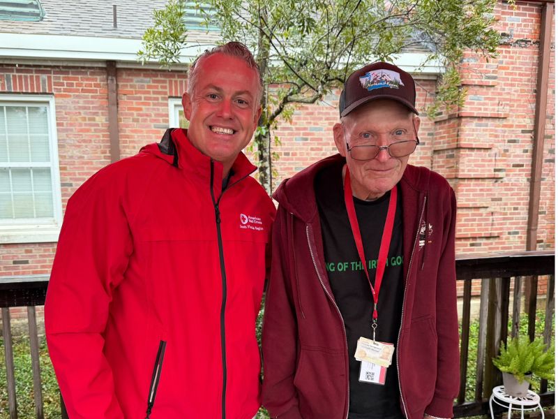 two red crossers smiling together