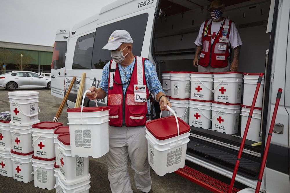 September 19, 2020. Pensacola, Florida
On September 19th, the Salvation Army set up a mobile kitchen to provide meals at the Equestrian Center. Nearby, the American Red Cross set up a cleanup kits distribution area to help residents of Pensacola and the surrounding areas as they work to clean up their homes while contending with power outages and downed trees. Dozens of cars lined up for a hot meal and relief items like shovels, gloves and tarps.
Photo by Jaka Vinsek/American Red Cross