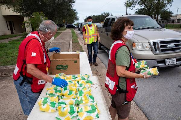 July 29, 2020. Lasara ,Texas.
Marjie Day and William Day of the American Red Cross help local fire fighters with a drive thru food distribution for residents affected by Hurricane Hanna, in Lasara, TX on Wednesday July 28, 2020.
Photo by Scott Dalton/American Red Cross