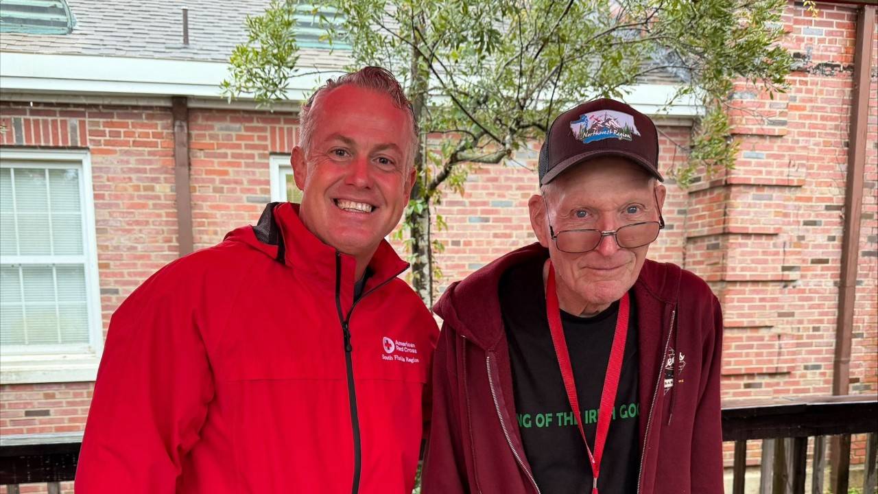 two red crossers smiling together