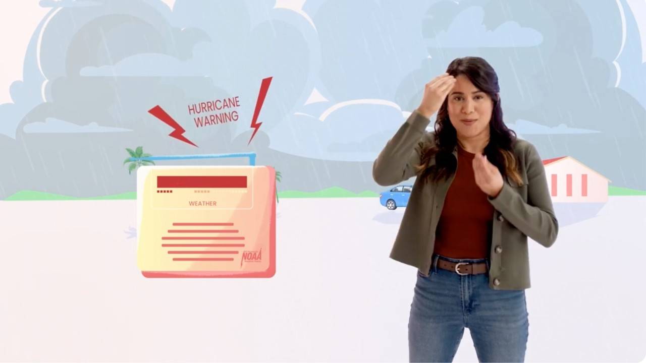 Person using American Sign Language stands in front of an illustrated storm scene with dark rain clouds, flooding, palm trees, a partially submerged vehicle, and a house in the background. The person is centered in the foreground, appearing to present emergency preparedness or weather safety information in ASL.