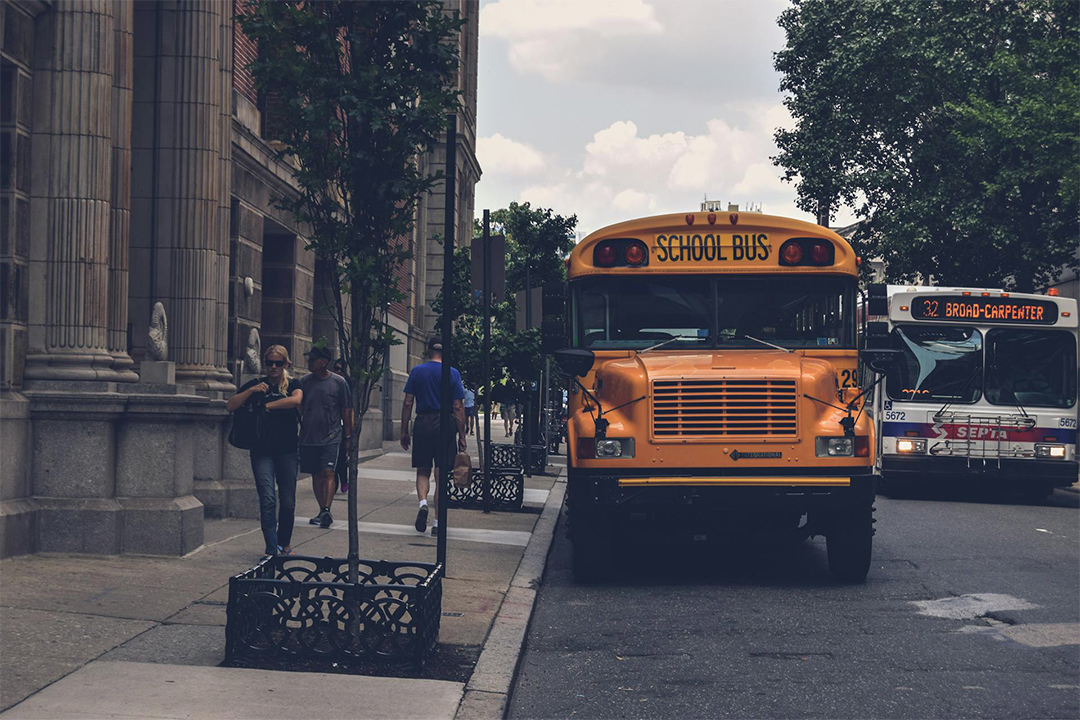 Yellow school bus on a city street.
