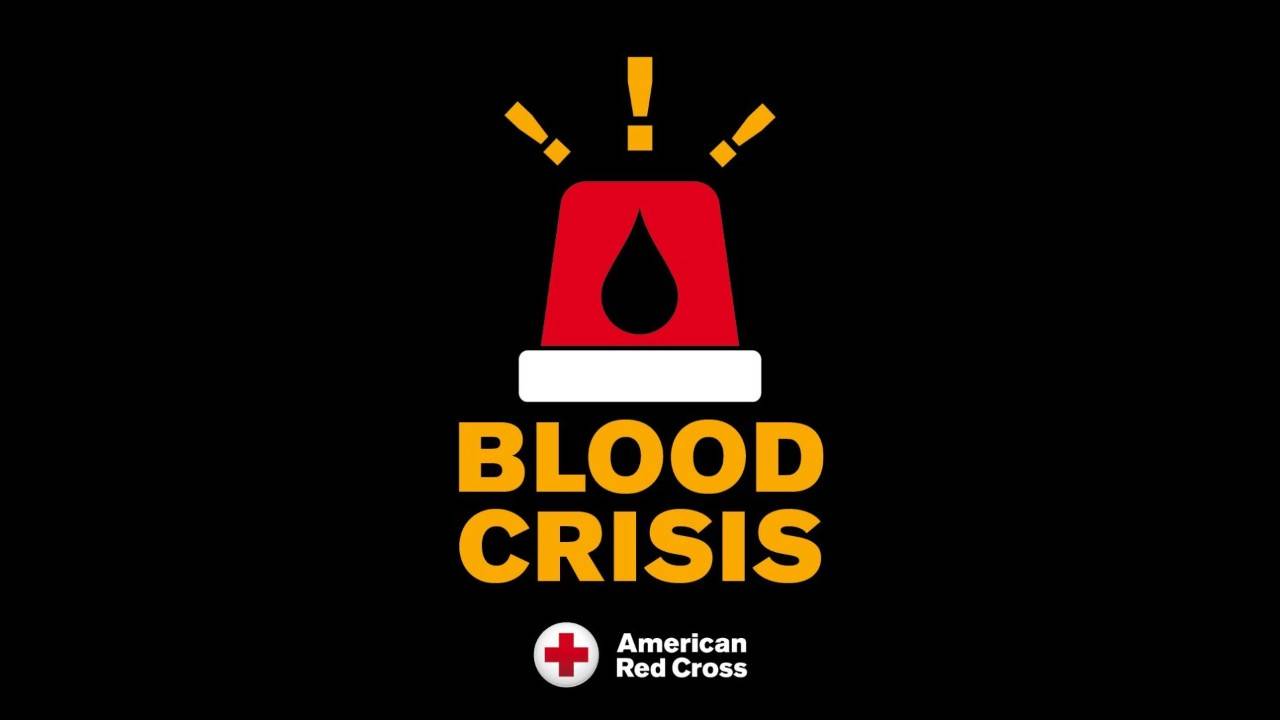 Graphic featuring a stylized red siren with light rays emitting from it and a blood droplet inside, set against a dark background with the bold text 'BLOOD CRISIS' and the American Red Cross logo below.