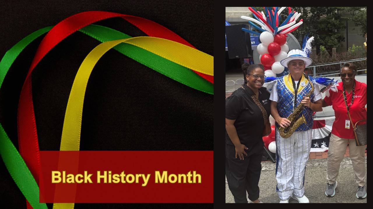 Carla Moore and Mary Harper stand with two men dressed like Mummers. 