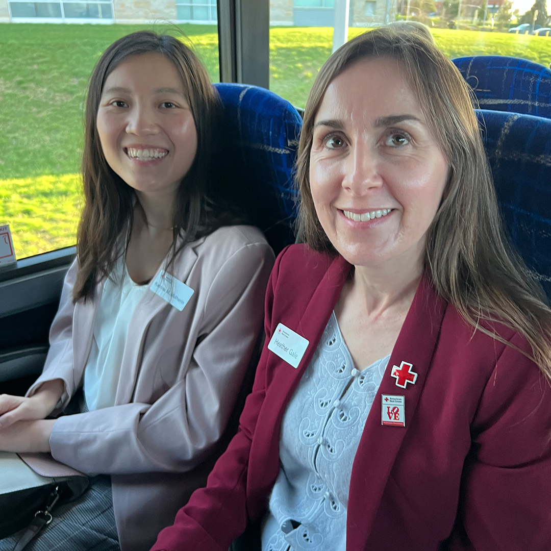 Photo of Red Cross staff Katrina Mulherin and Heather Gale sit on a bus.