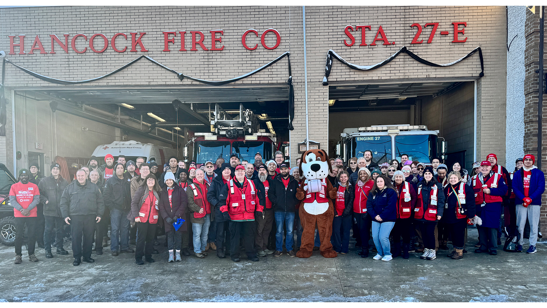 A group of about 70 people stand in front of the Hancock Fire Company.