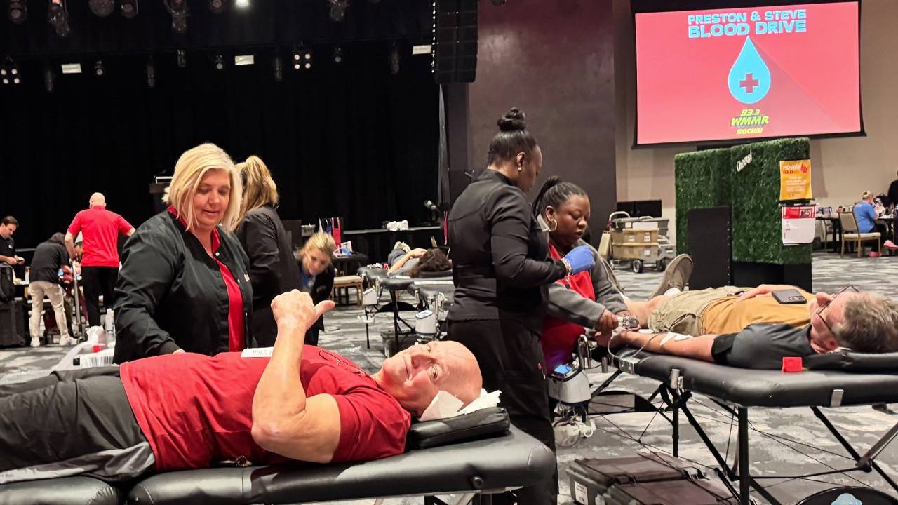 Steve Morrison gives a thumbs up as he donates blood. Preston is on the cot to Steve’s right, also donating.