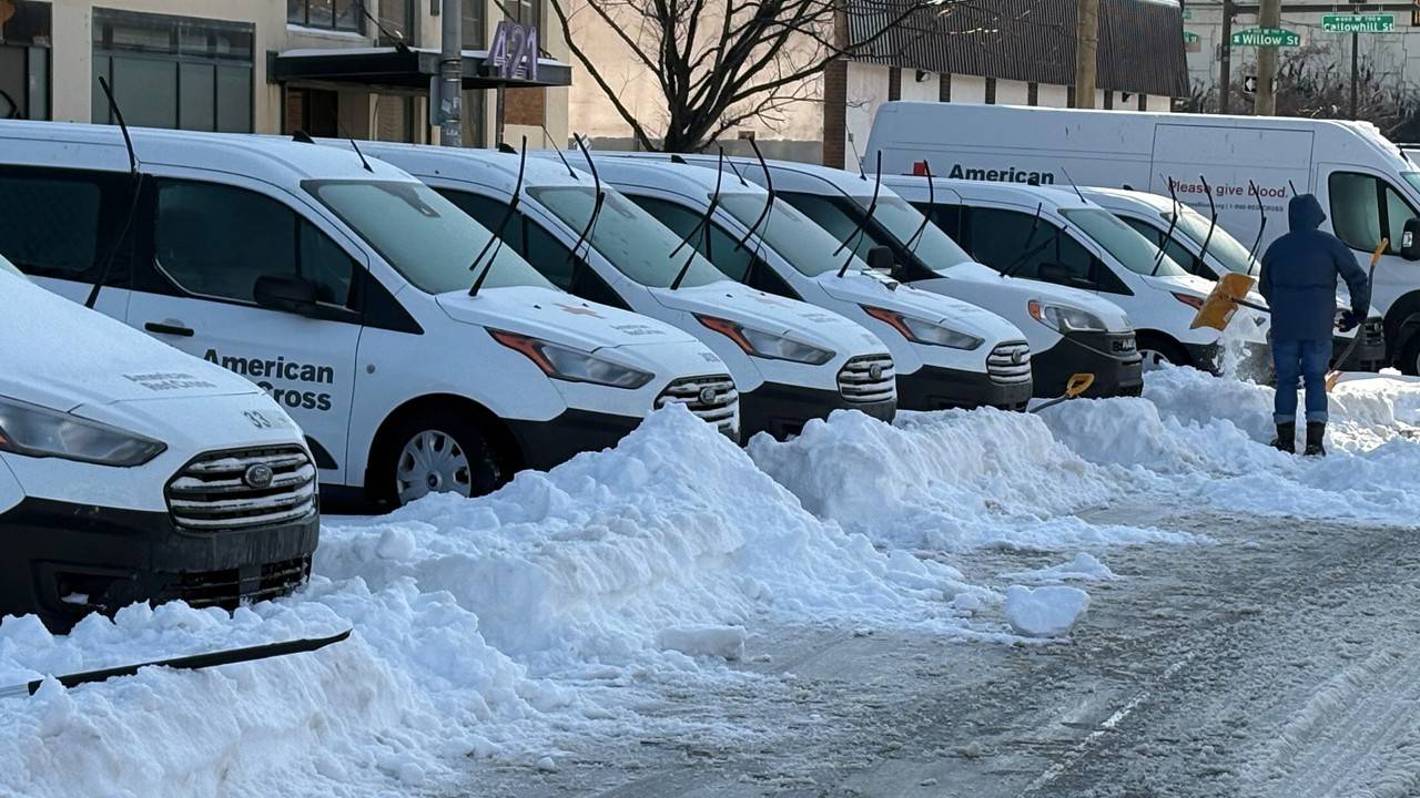 Red Cross vehicles parked in the snow.