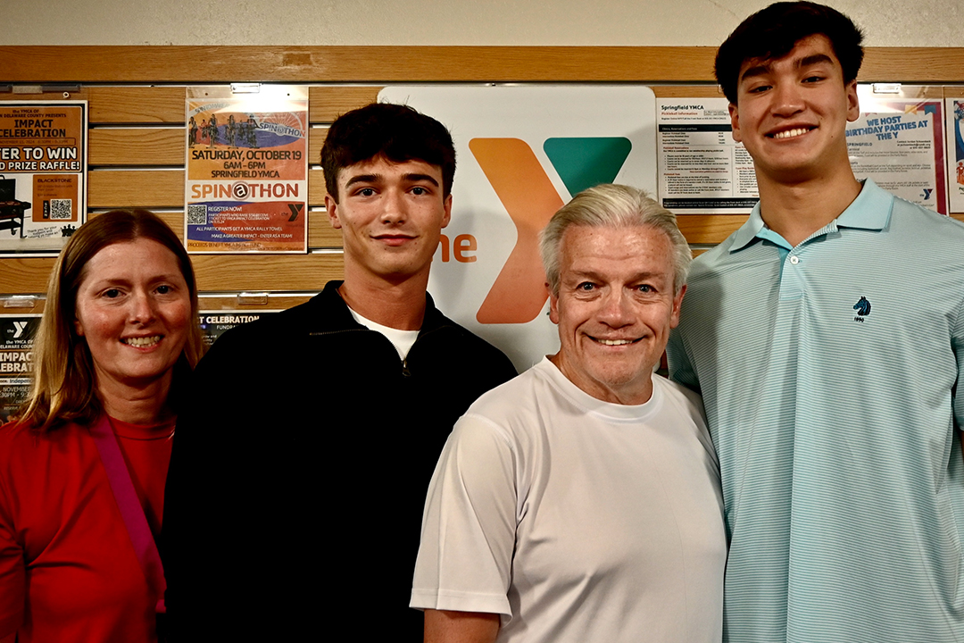 Jim McBride stands with YMCA lifeguards Carlotta Myers, Peter McMonagle and Gabe DiEmidio who helped save his life when he went into cardiac arrest.