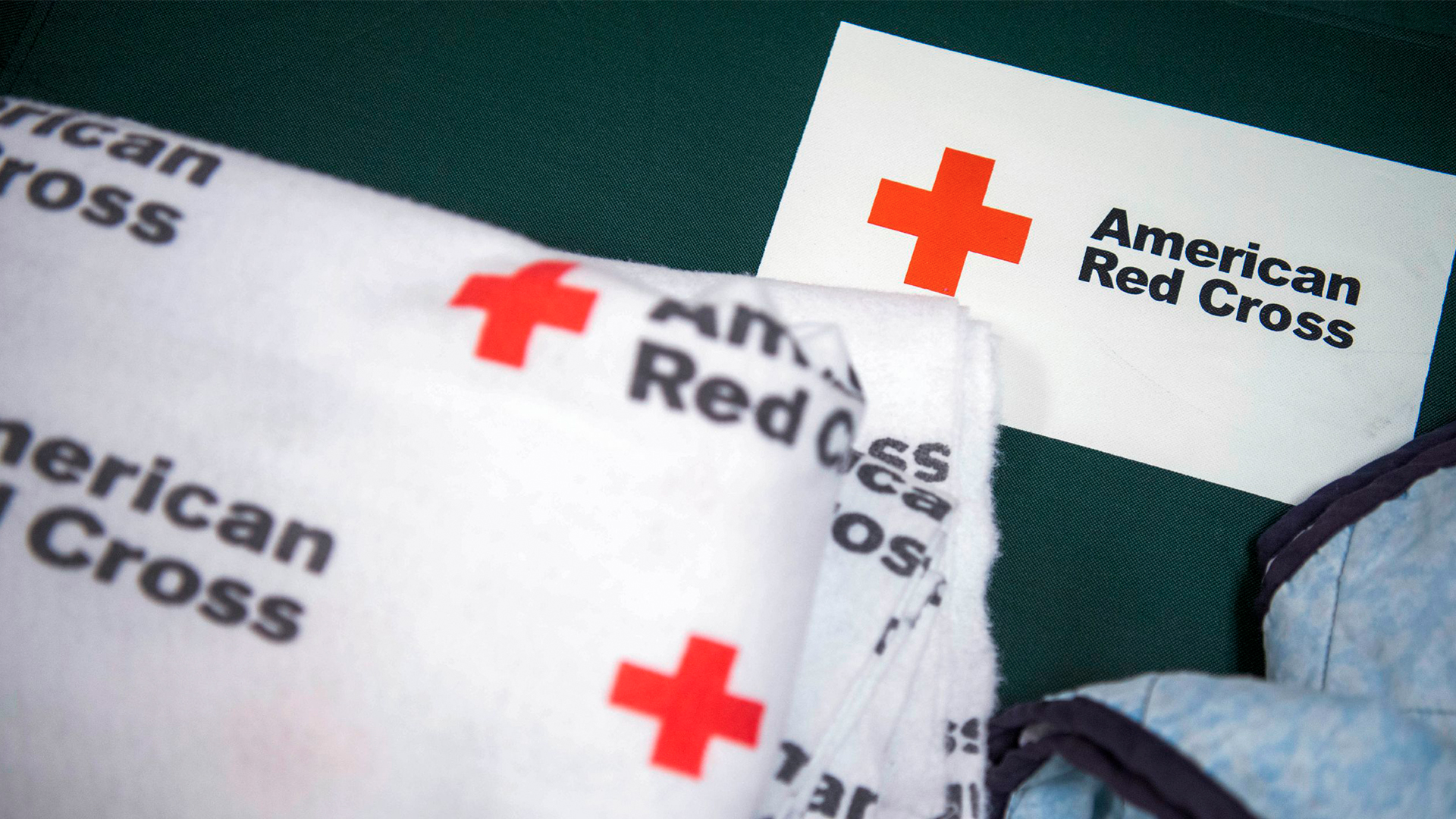 Photo of a Red Cross blanket on a cot. 