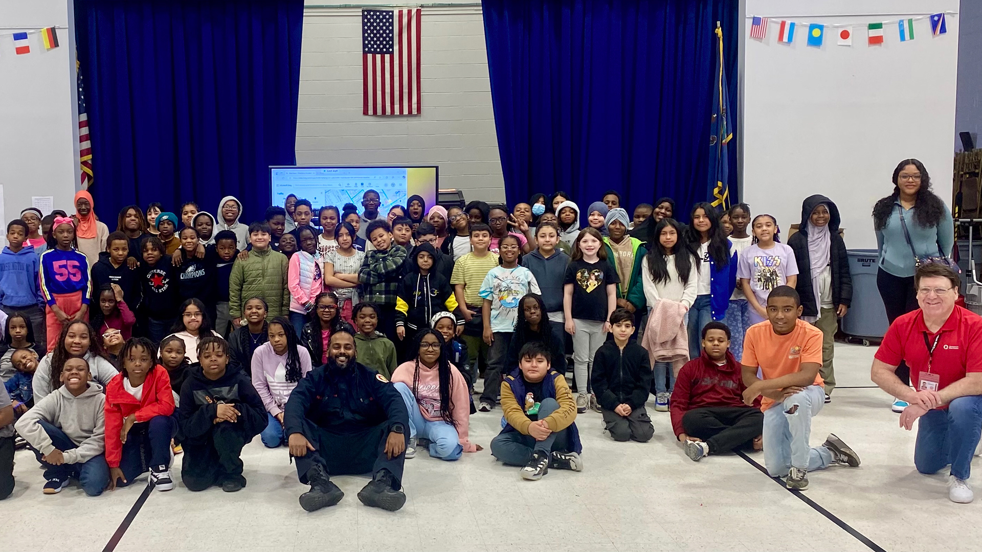 Large group photo of fifth graders in front of cafeteria stage at Stonehurst Elementary School in Upper Darby. 