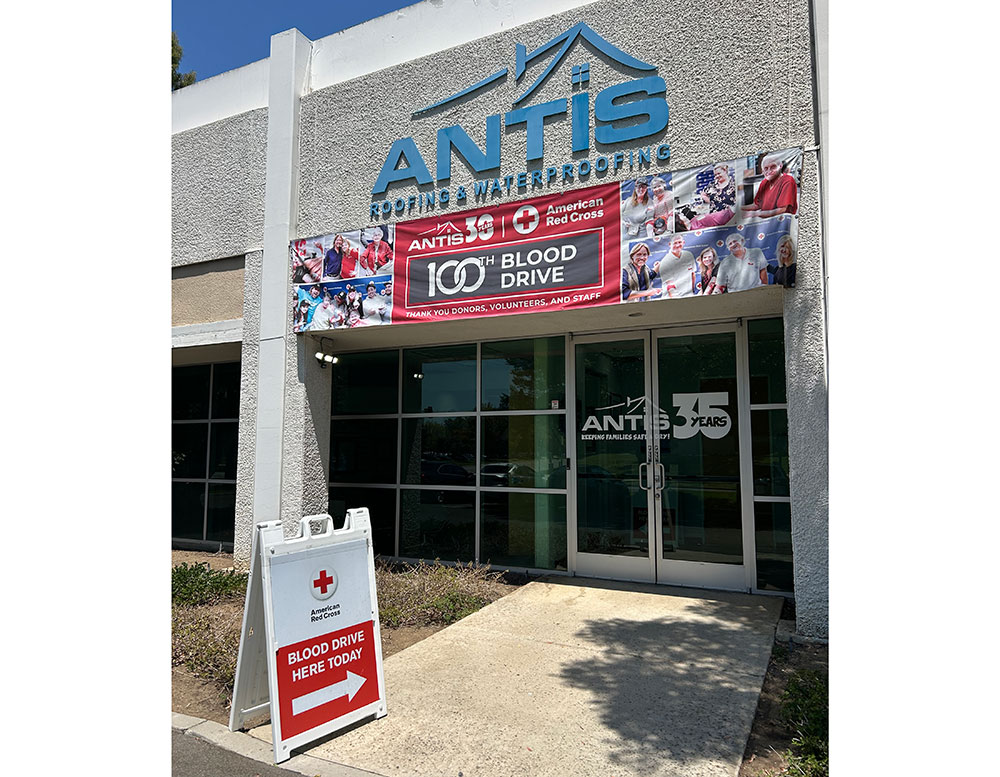 front view of the Antis Roofing and Waterproofing building with a Red Cross blood drive sign by the front door.