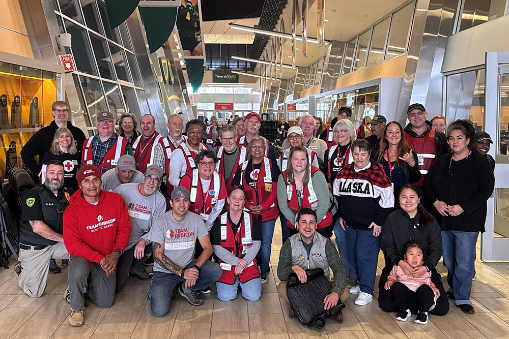 Group photo of Red Cross volunteers in an airport lobby.