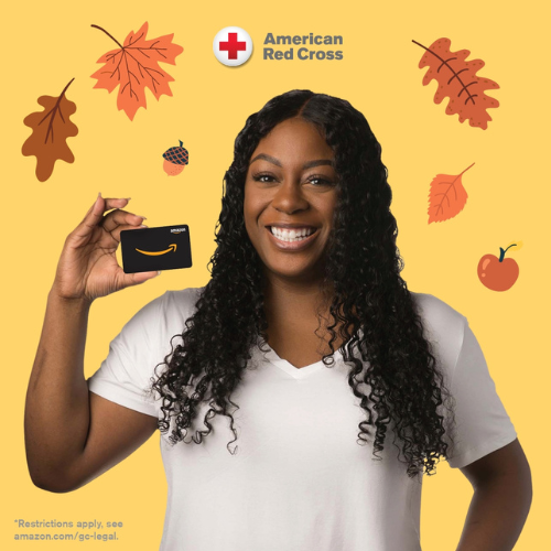 Woman holding up gift card and smiling.