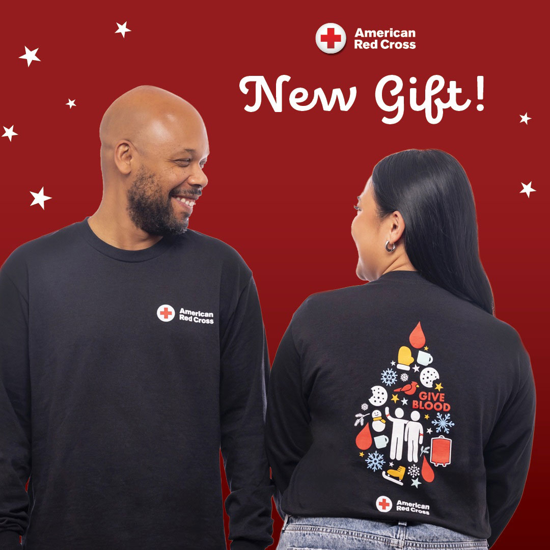 Two people wearing Red Cross holiday long sleeve shirts.