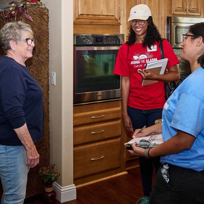 volunteers smiling at resident