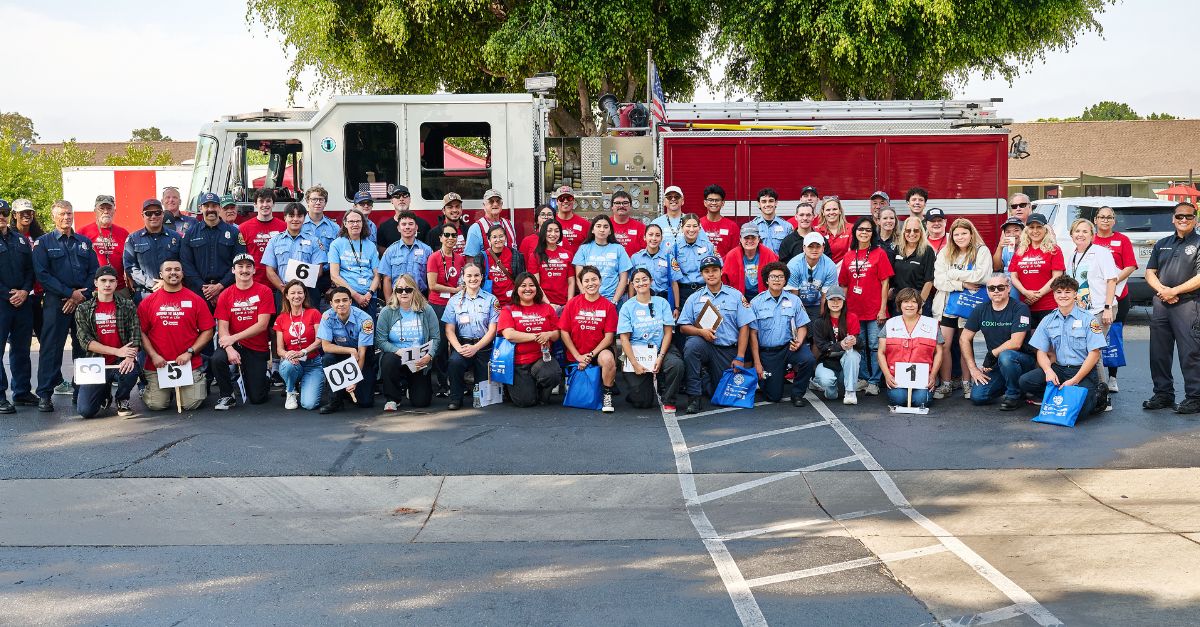sound the alarm volunteers and community members in front of fire truck.
