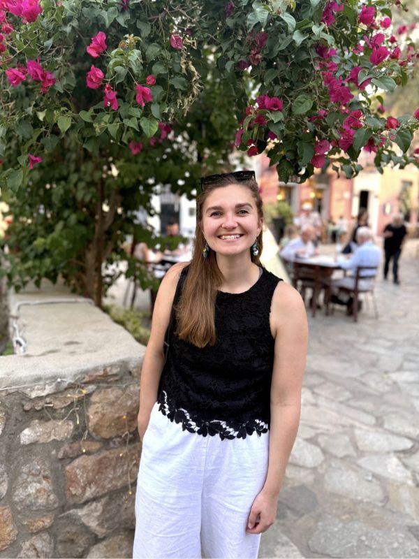 woman outside near a flower bush