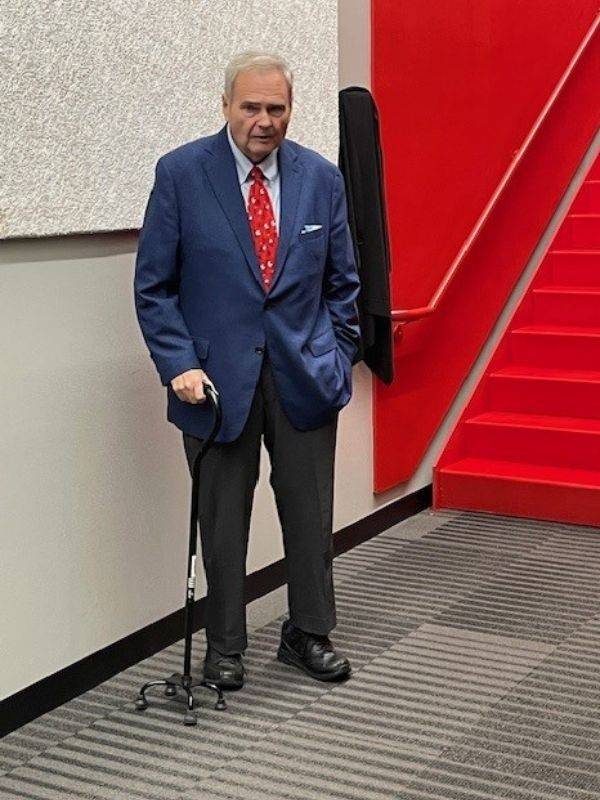 buck lewis standing in front of stairway